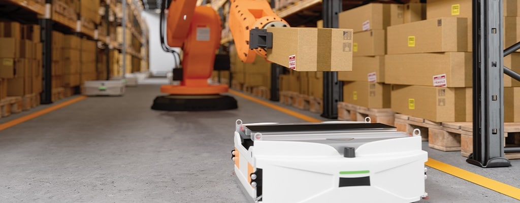 AGV vehicles moving boxes through a warehouse